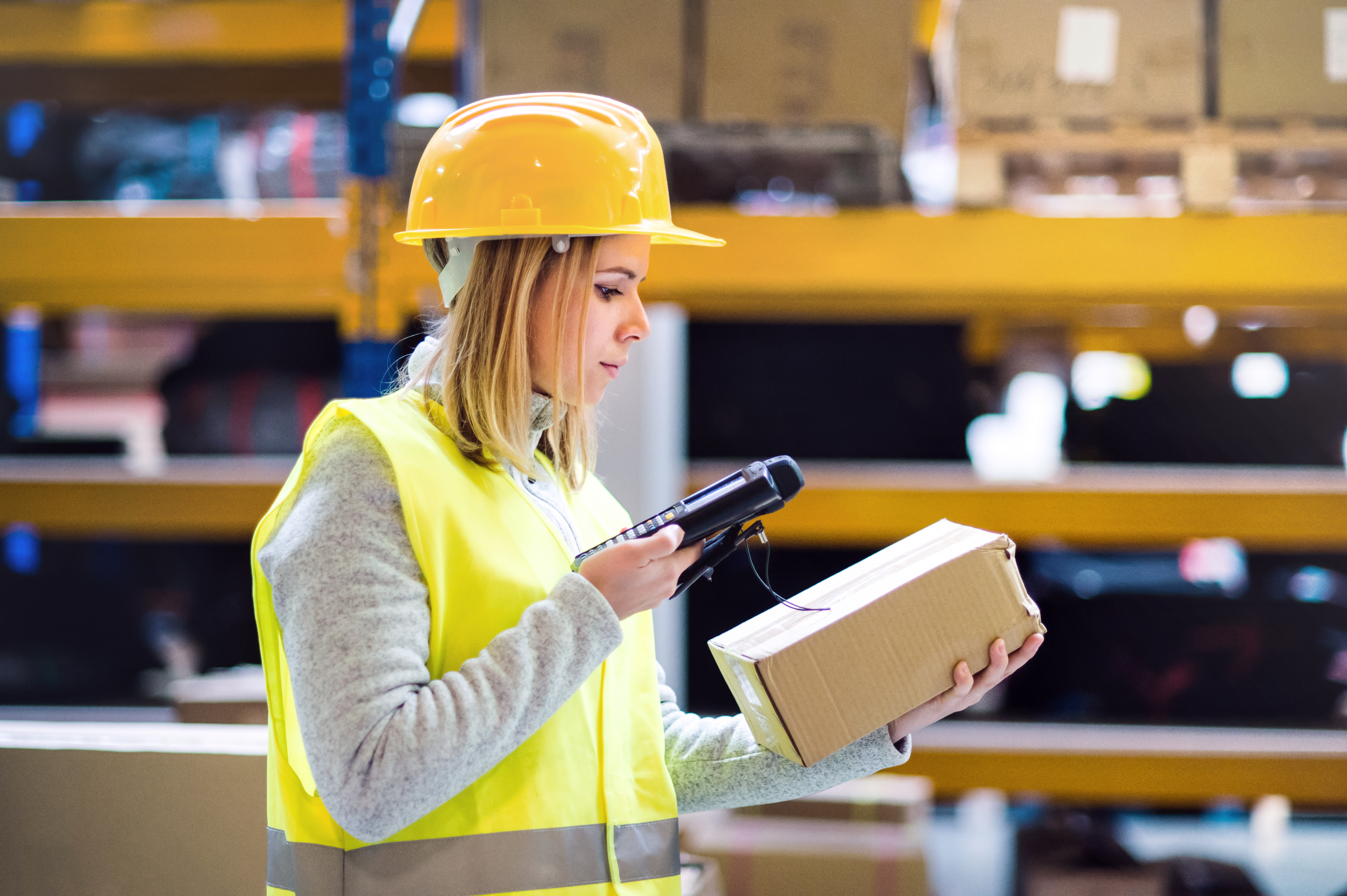 someone manually scanning a package in a warehouse