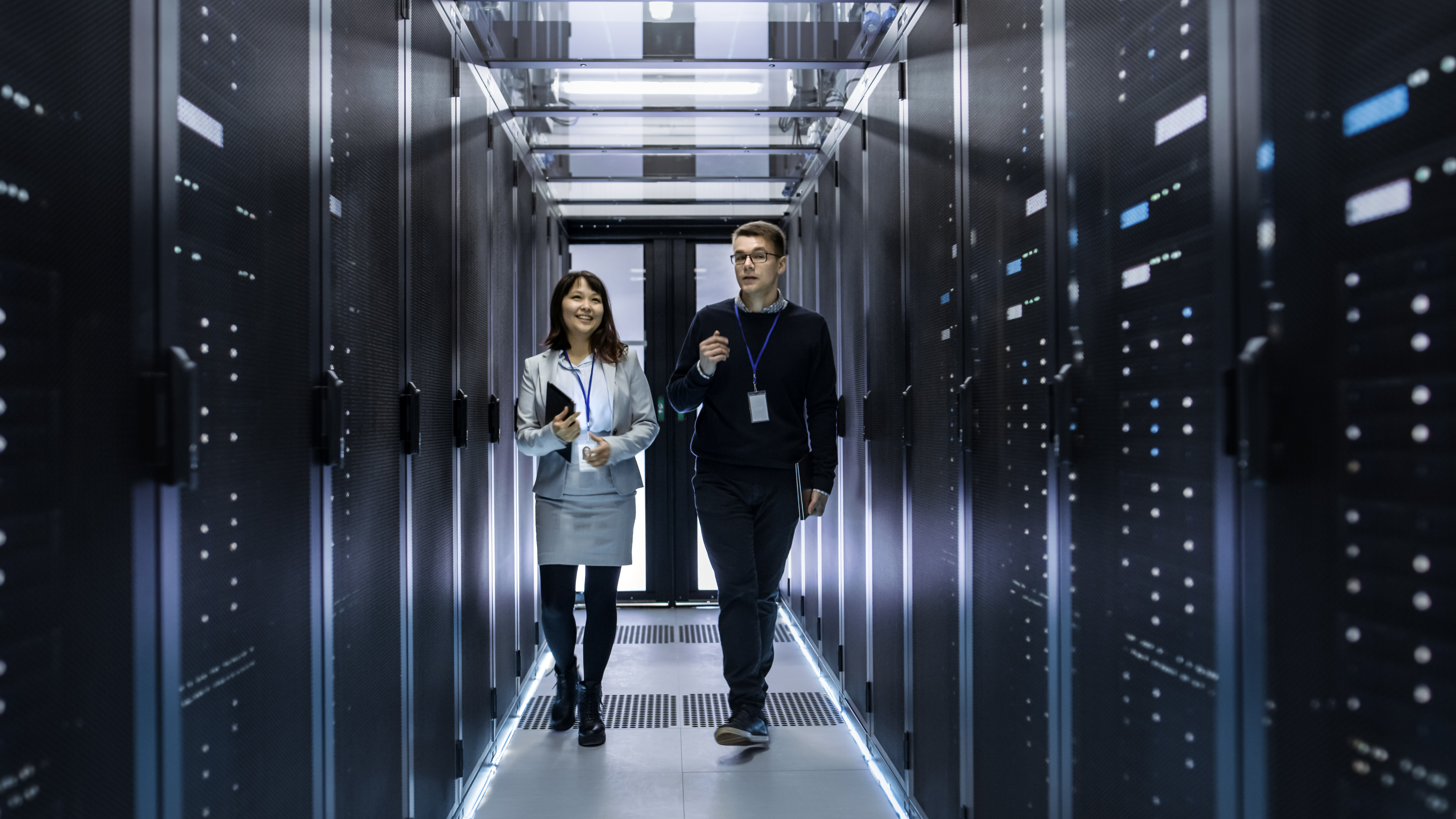 two people walking through a data center