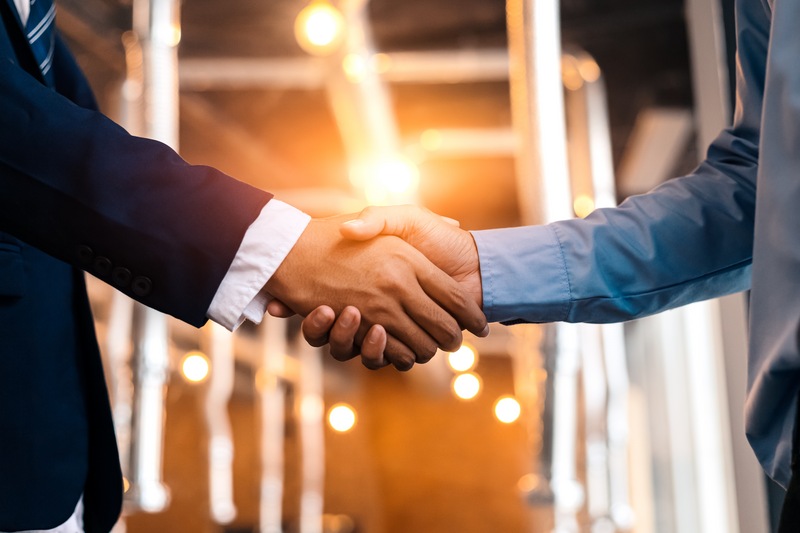 business shaking hands, finishing up meeting. successful businessmen handshaking after good deal.