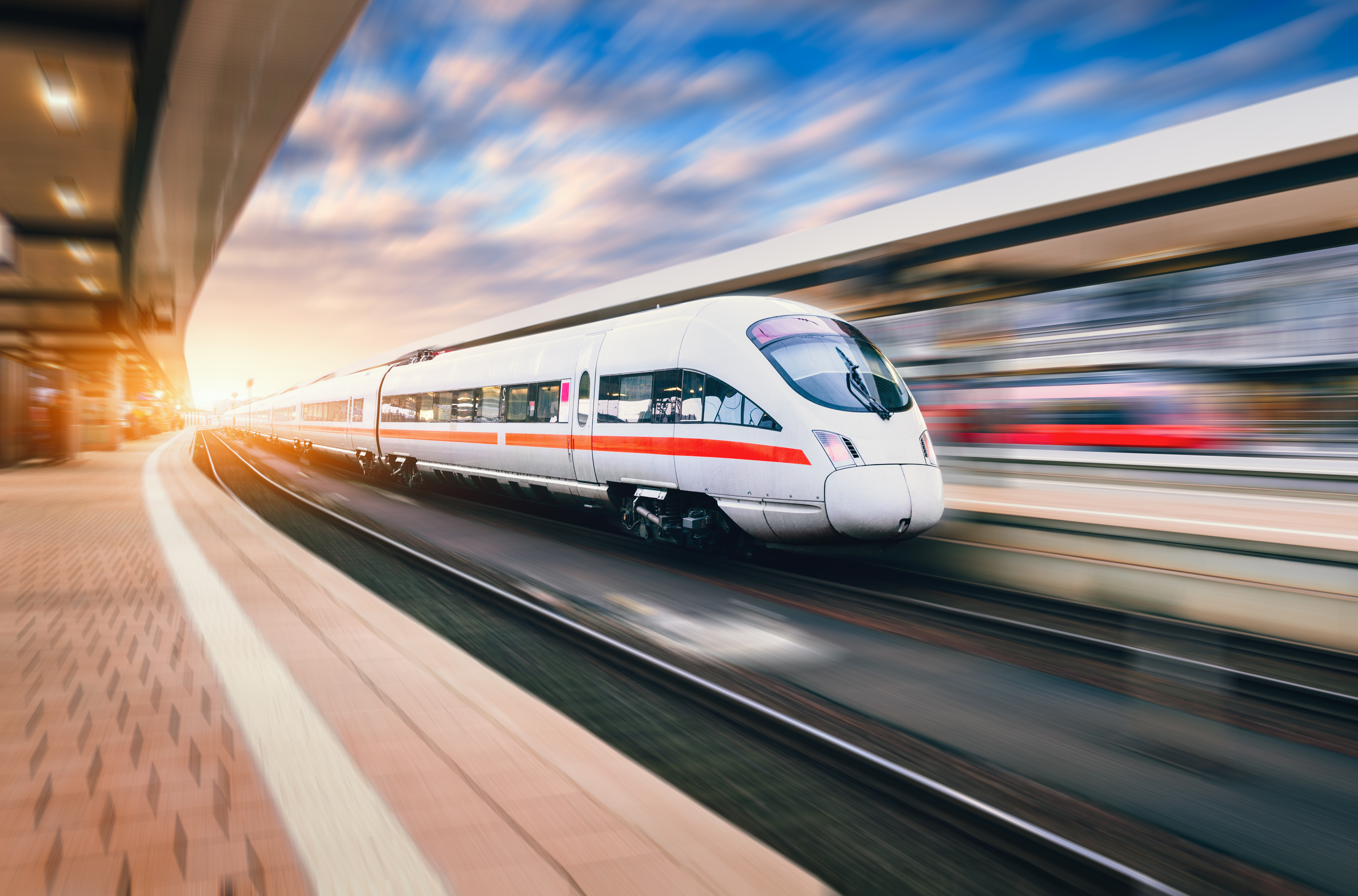 White high-speed commuter train in motion.