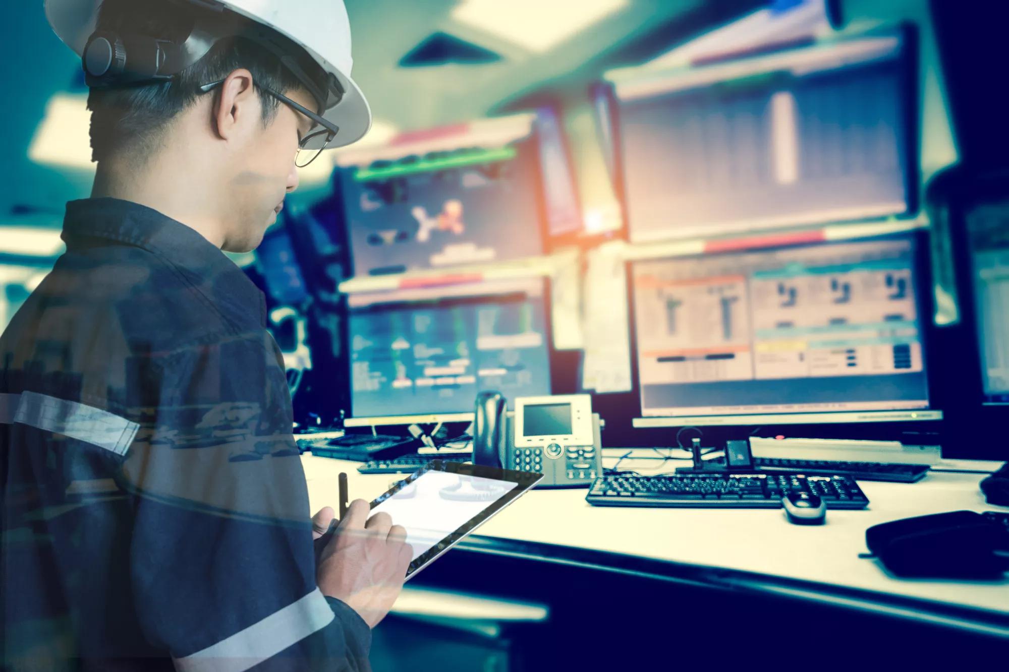 double exposure of  engineer or technician man in working shirt  working with tablet in control room of oil and gas platform or plant industrial for monitor process, business and industry concept