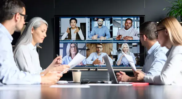 global corporation online videoconference in meeting room with diverse people sitting in modern office and multicultural multiethnic colleagues on big screen monitor. business technologies concept.