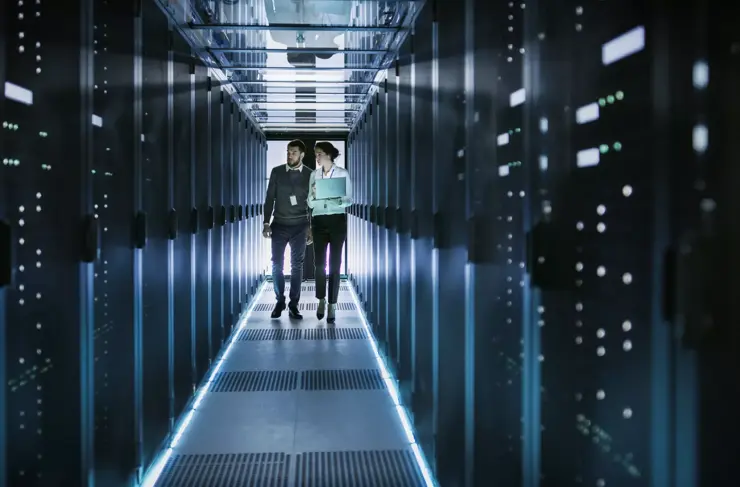 Data-Center-Workers-Walking-Server-Cabinets-Aisle