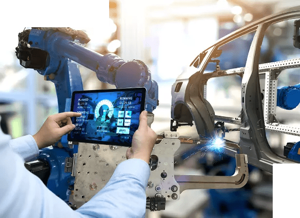 Tech using tablet to monitor robotic welding arm in automotive manufacturing plant.