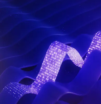 Blue abstract background with light traveling through abstract flat cable illustrating data flow (3D render)