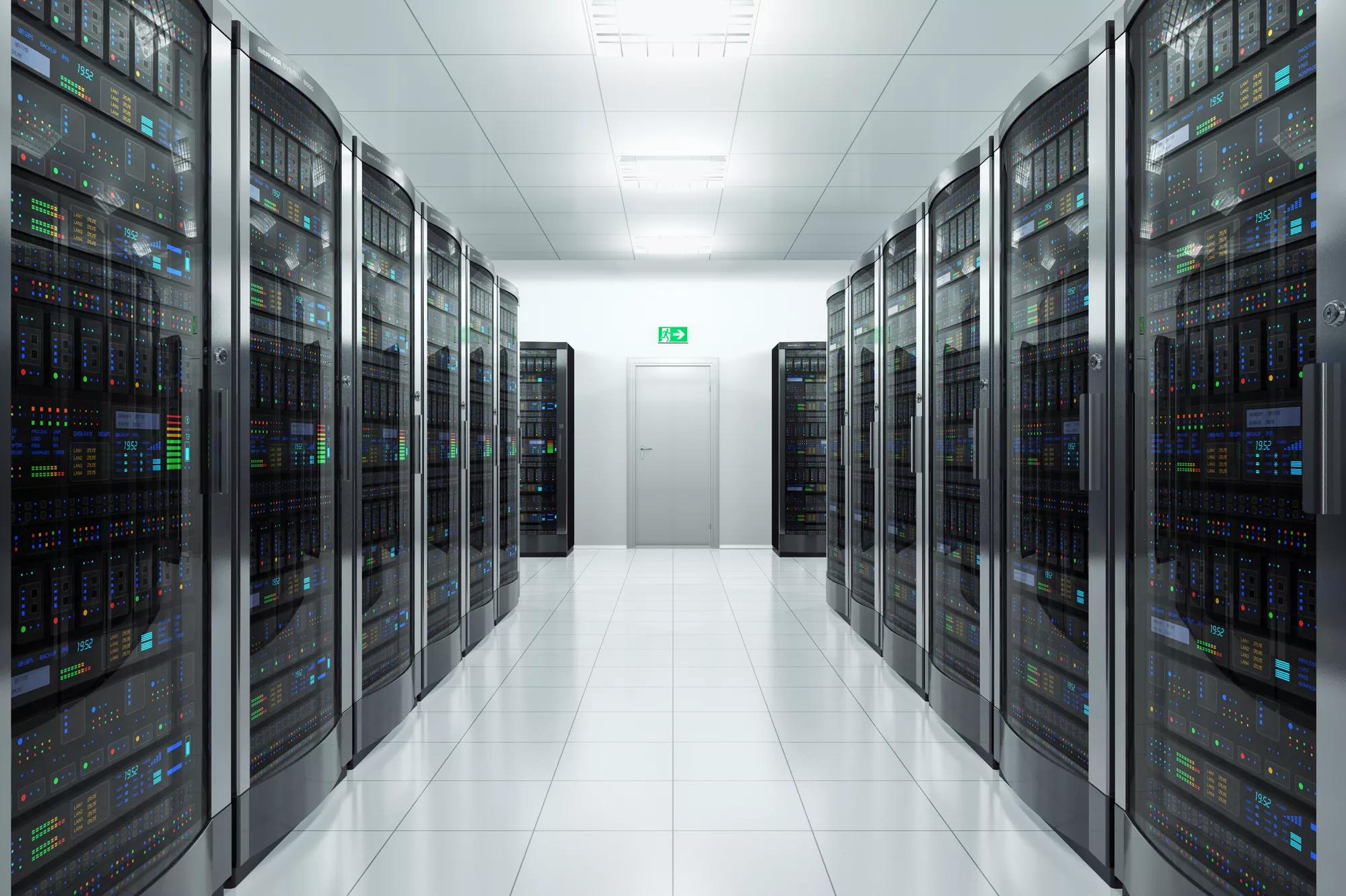 Pristine aisles of black server cabinets & networking equipment in data center.