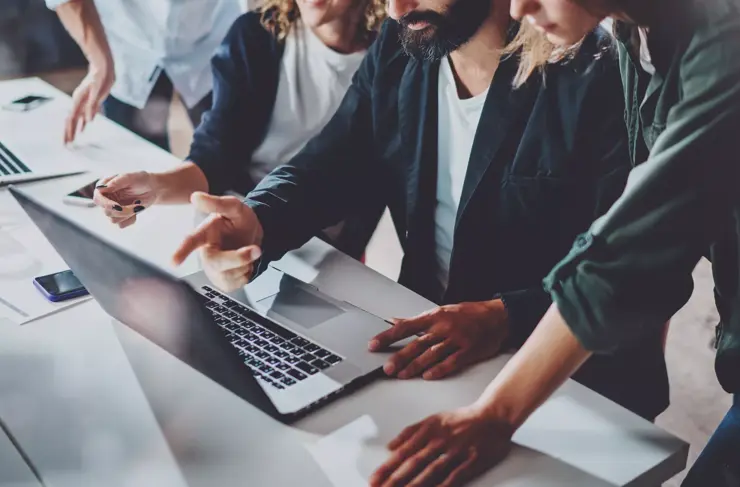 Working process at office.Group of young coworkers work together modern coworking studio.Young people making conversation with partners.Horizontal Wide.Blurred background