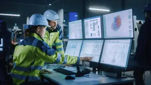 industry 4.0 modern factory: project engineer talks to female operator who controls facility production line, uses computer with screens showing ai, machine learning enhanced assembly process