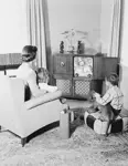 mother and children watching television.