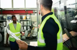 Two operators from the factory handling the equipment