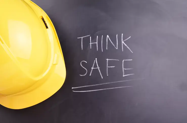 Work Place Safety Concept with safety equipment and a blackboard in the background