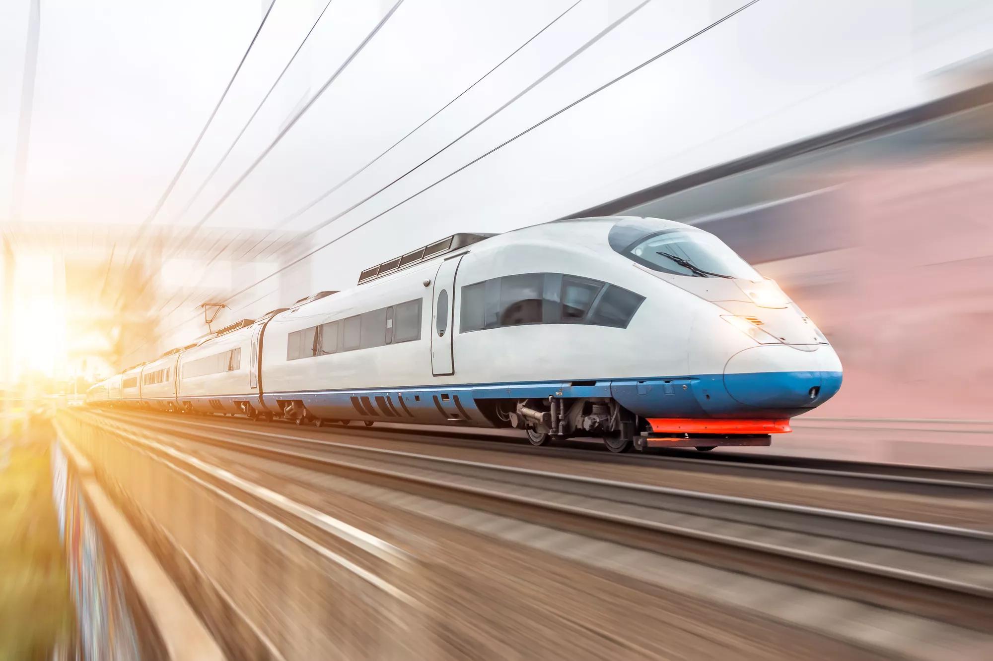 High speed fast train passenger locomotive in motion at the railway station city