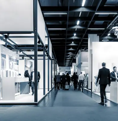 business people walking between trade show booths. ideal for websites and magazines layouts