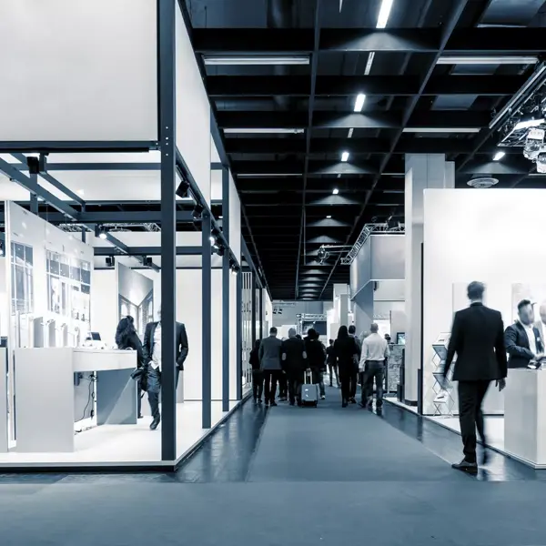 business people walking between trade show booths. ideal for websites and magazines layouts