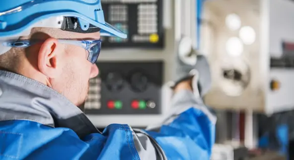 Computer Numerical Control Lathe Machine Operator. CNC Caucasian Technician.MEtworking Industry Equipment.