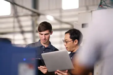 it support technicians inspecting machine
