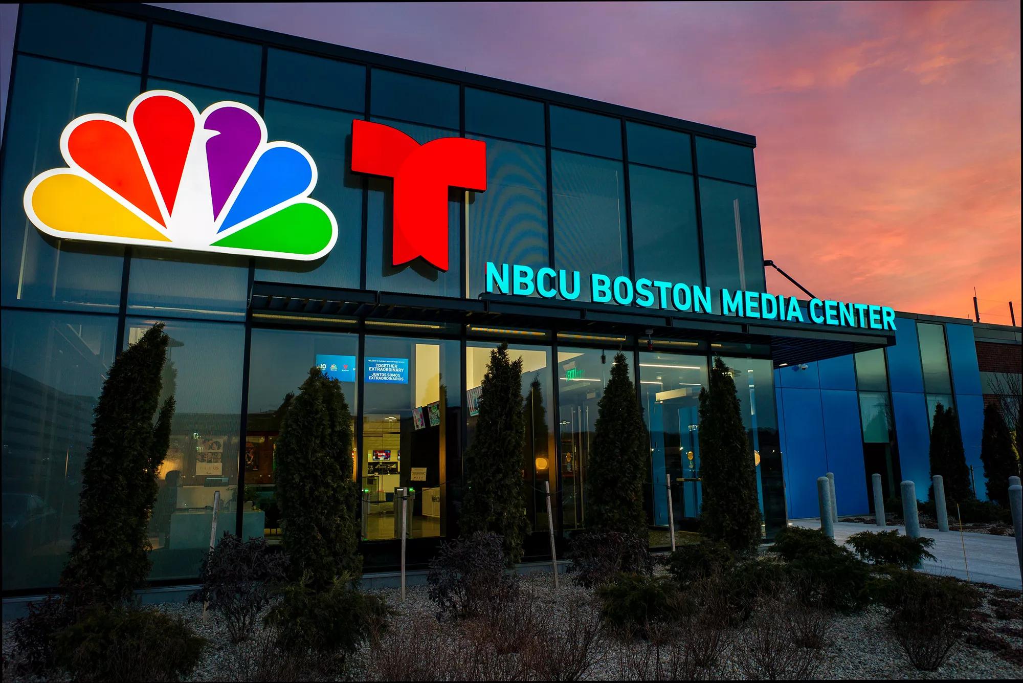 Front view, NBCU Boston Media Center, LED lighting & glass entry at dusk