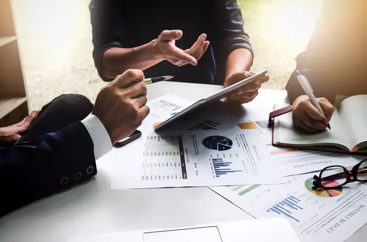 Business-People-Collaborating-over-Paperwork