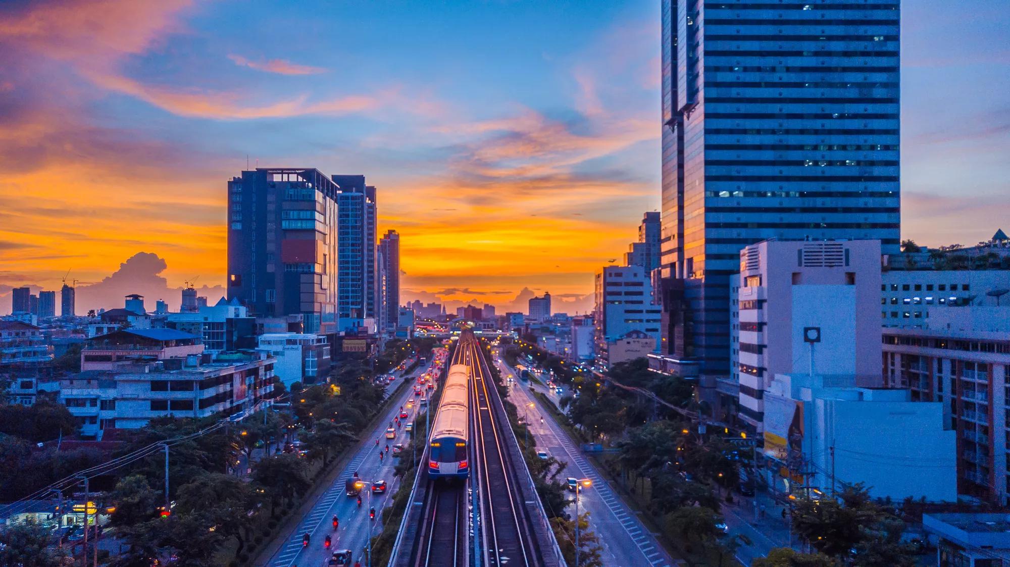 Sky train mass transit system in Bangkok City moving to alive in platform at sunset, Bangkok, Thailand.