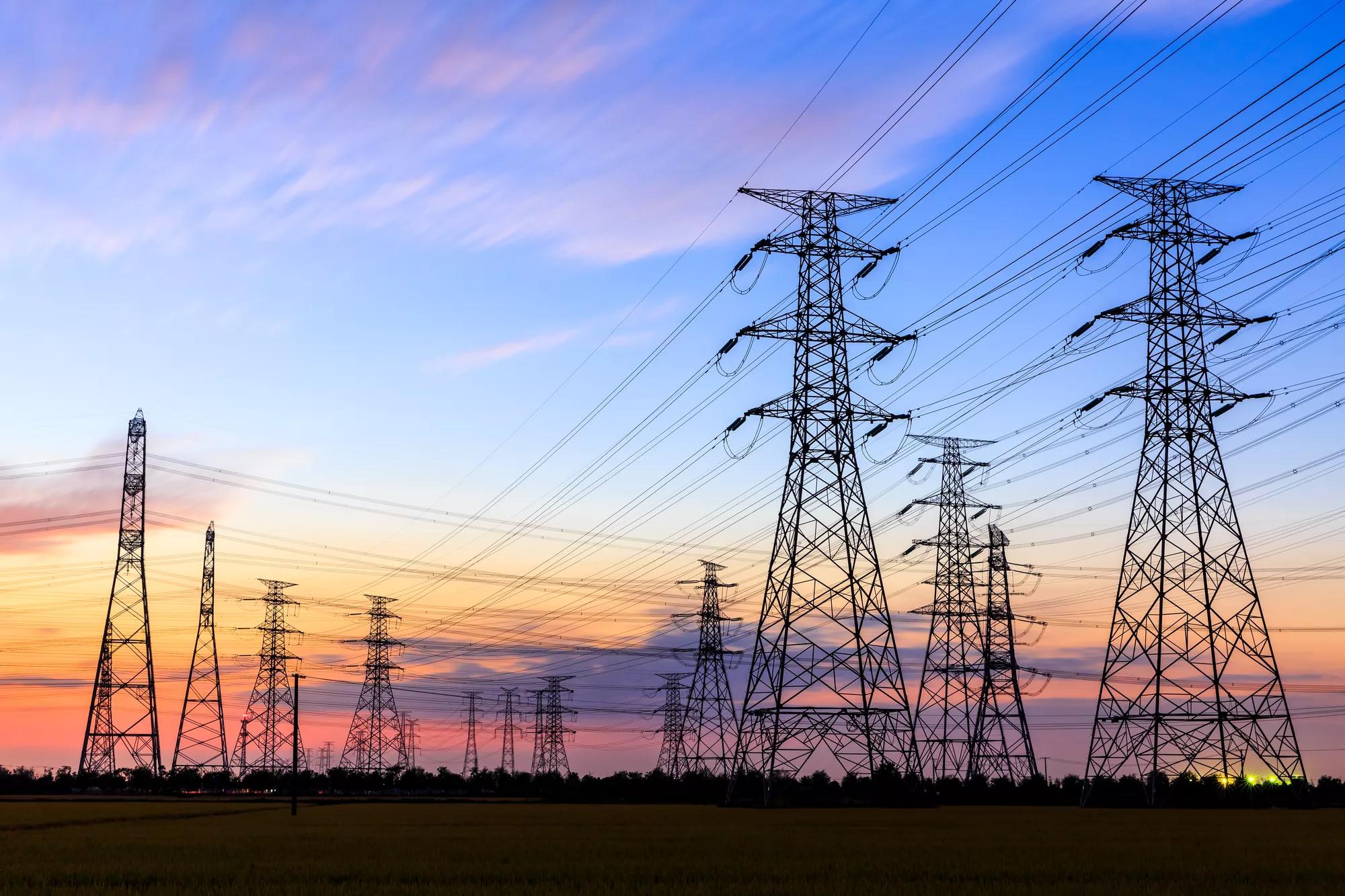 high-voltage power lines at sunset,high voltage electric transmission tower