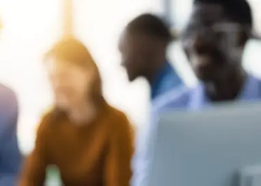 Defocused bokeh effect positive concept background of unrecognizable people diverse business team meeting of young professionals corporate startup