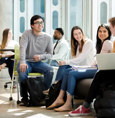 A group of college students gather in common area