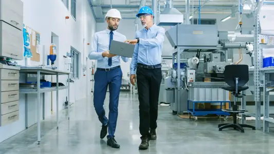 businessmen-walking-on-factory-floor