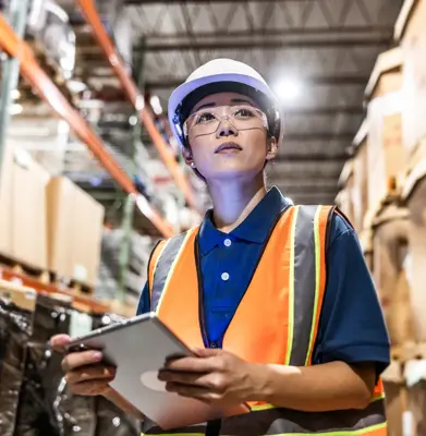 warehouse employee taking inventory with digital tablet
