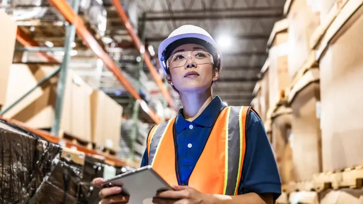 warehouse employee taking inventory with digital tablet