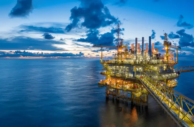 Panorama of Oil and Gas central processing platform in twilight, offshore hard work occupation twenty four working hours. 