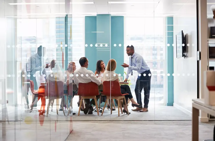 Professionals-Working-Contemporary-Boardroom-Behind-Glass