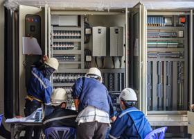 Engineer working on checking and maintenance equipment at wiring on PLC cabinet, Engineer checking status step up transformer
