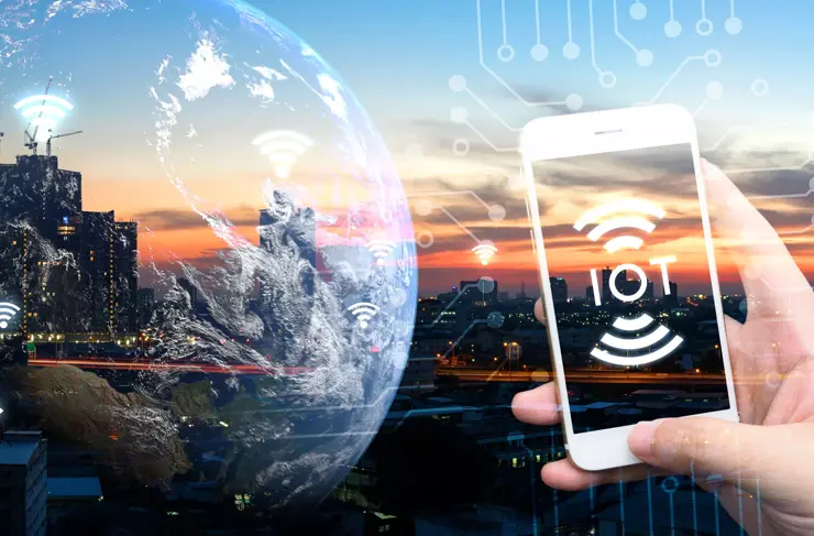 Internet of things , iot , smart home , smart city and network connect concept. Human hand holding white phone and iot icon with city sunset view and earth furnished by NASA. background and wifi icons
