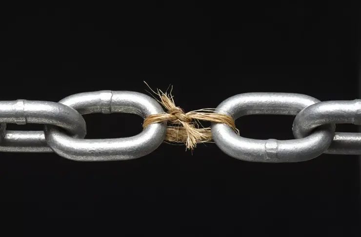 Metal chain with link missing replaced by rope on black background