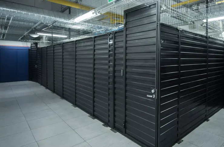 A big data center storage ranges cover and cloud services. Black cabinets in a large room servers.