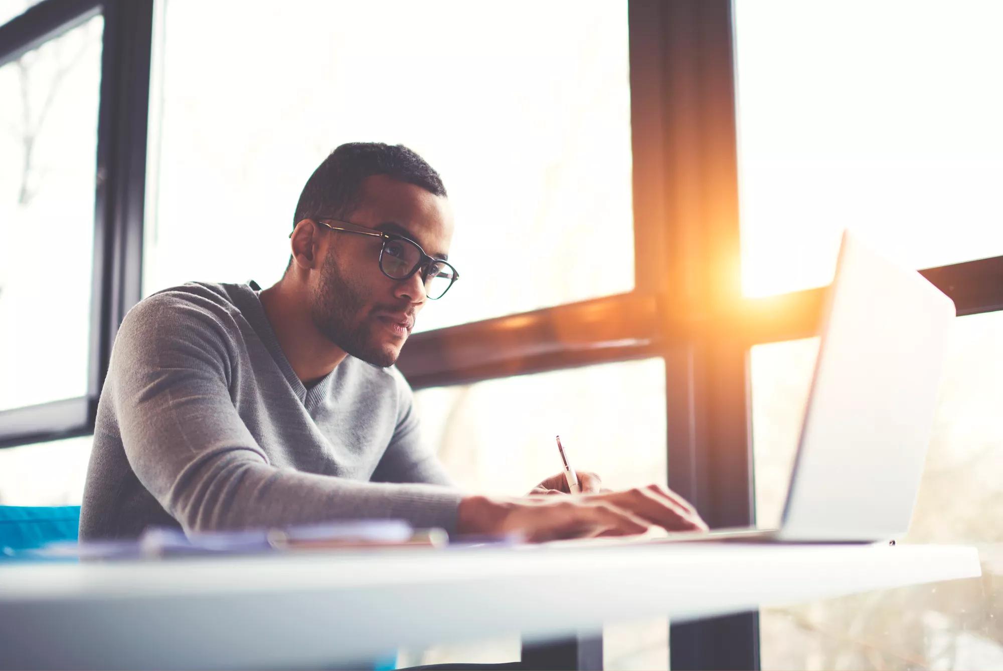 Business associate working on a laptop, wireless, smart building