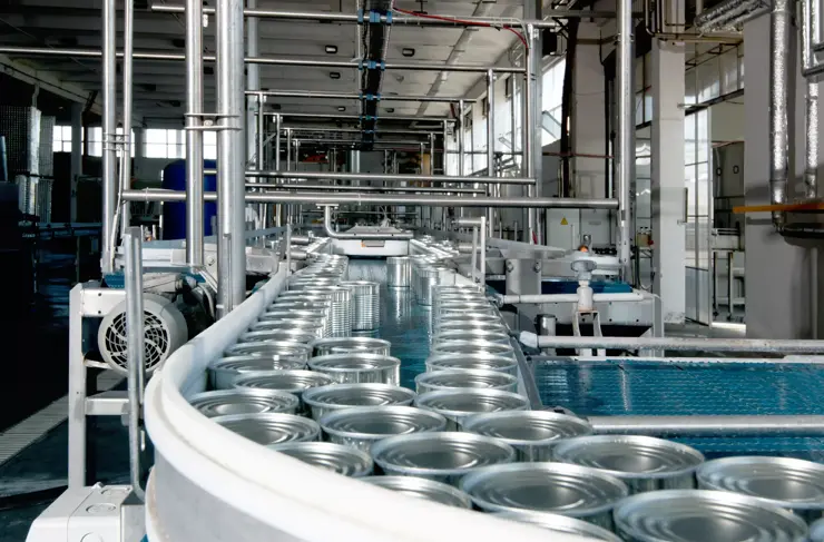 aluminum cans for food processed in factory line conveyor machine at canned food manufacturing, selective focus