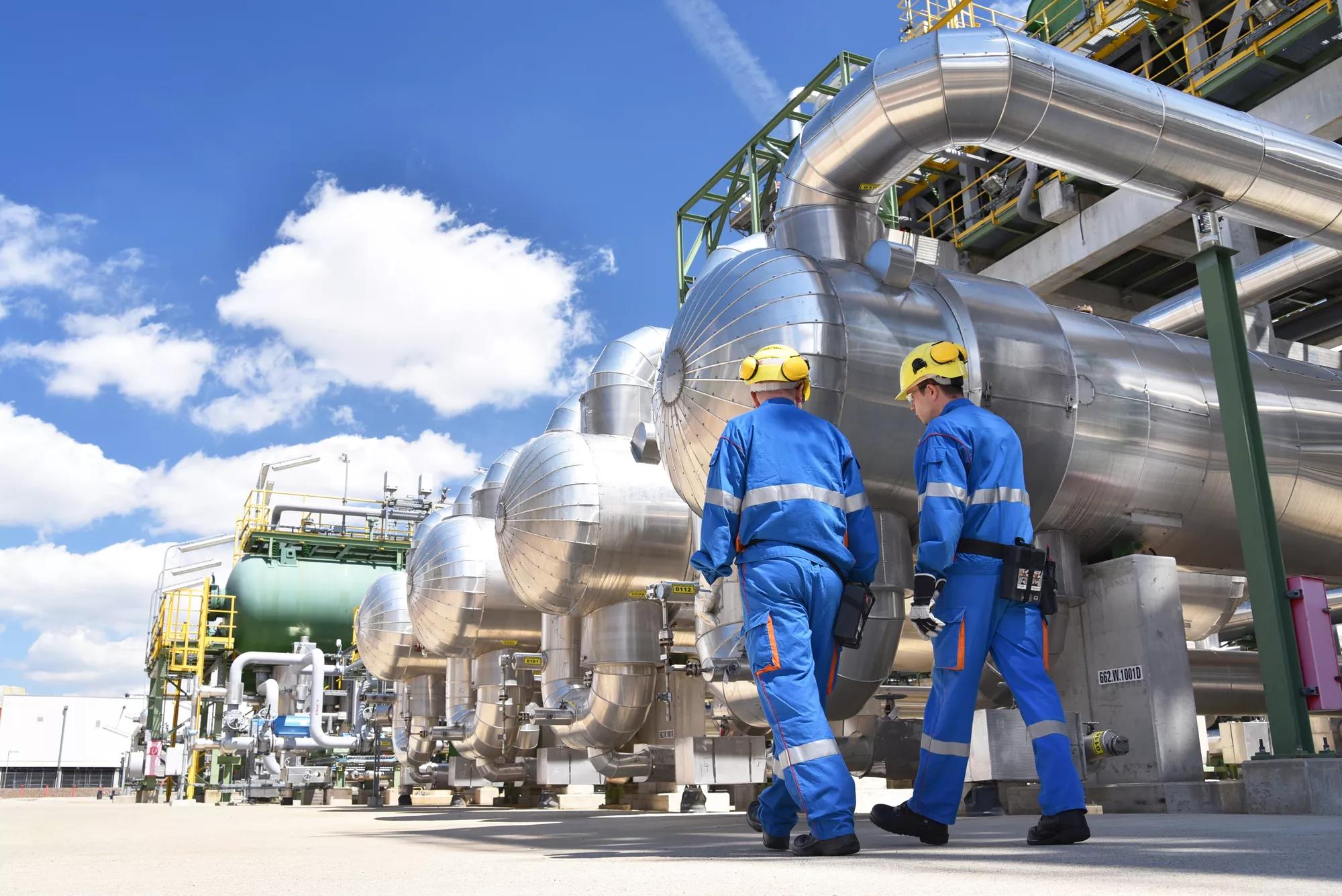 workers in an industrial plant for the production and processing of crude oil 