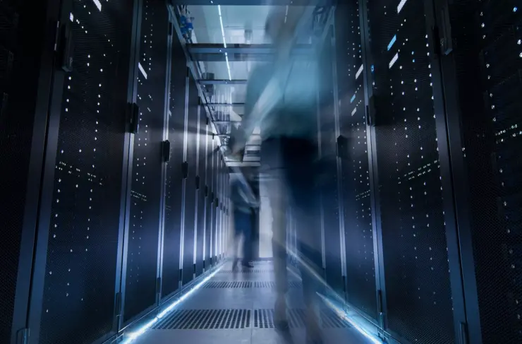 Shot of Corridor in Large Data Center Full of Moving and Working People. Pronounced Motion Blur.