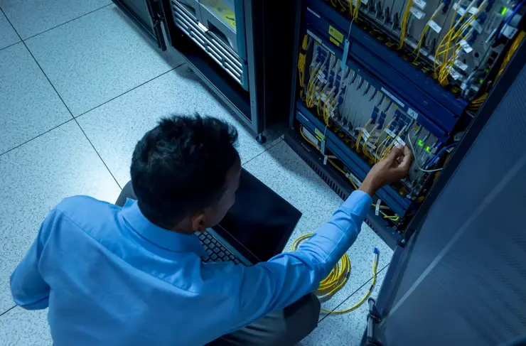 Network administrator working in data center room