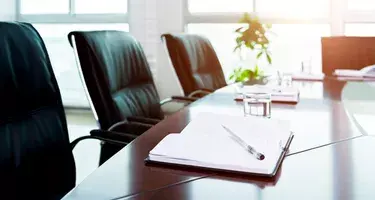 Vacant board room with diary & pen placed on conference table