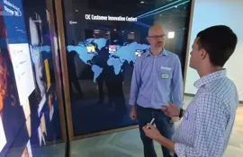 Belden associates brainstorm in front of backlit panels in Customer Innovation Center.