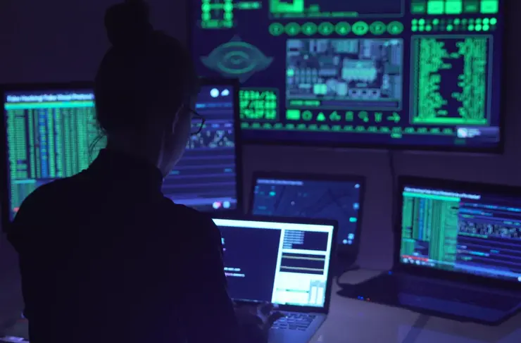 cyber analyst monitors network security & performance in dark control hub with complex dashboards