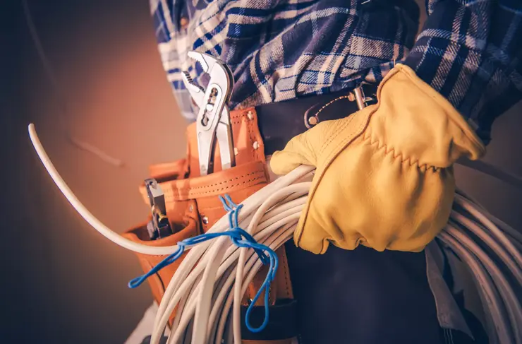 Electrician with Electric Cable Preparing For Installation in the Newly Constructed Building.
