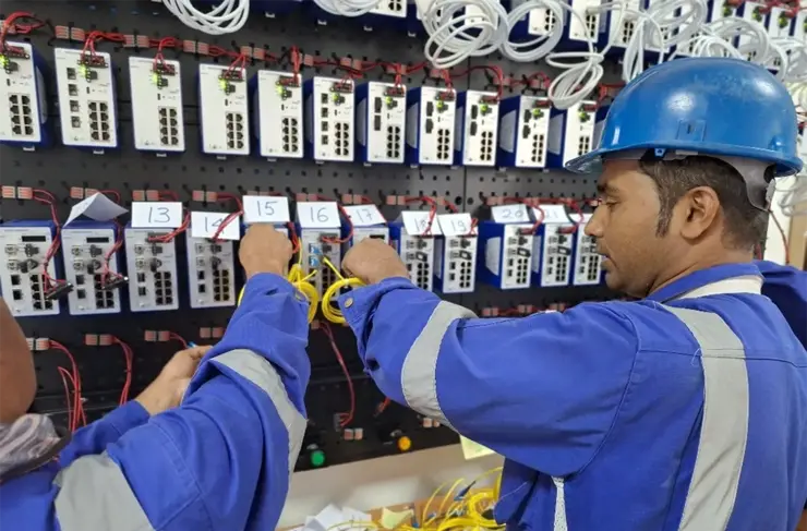 man with blue hard hat working on switches - customer image for zms qatar case study